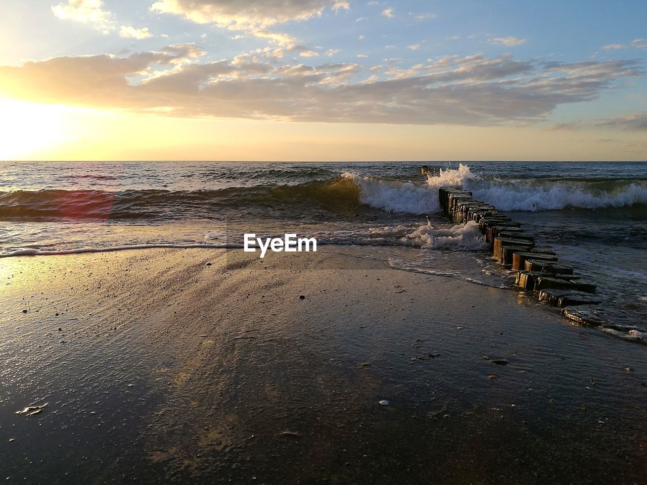 Scenic view of beach against sky during sunset