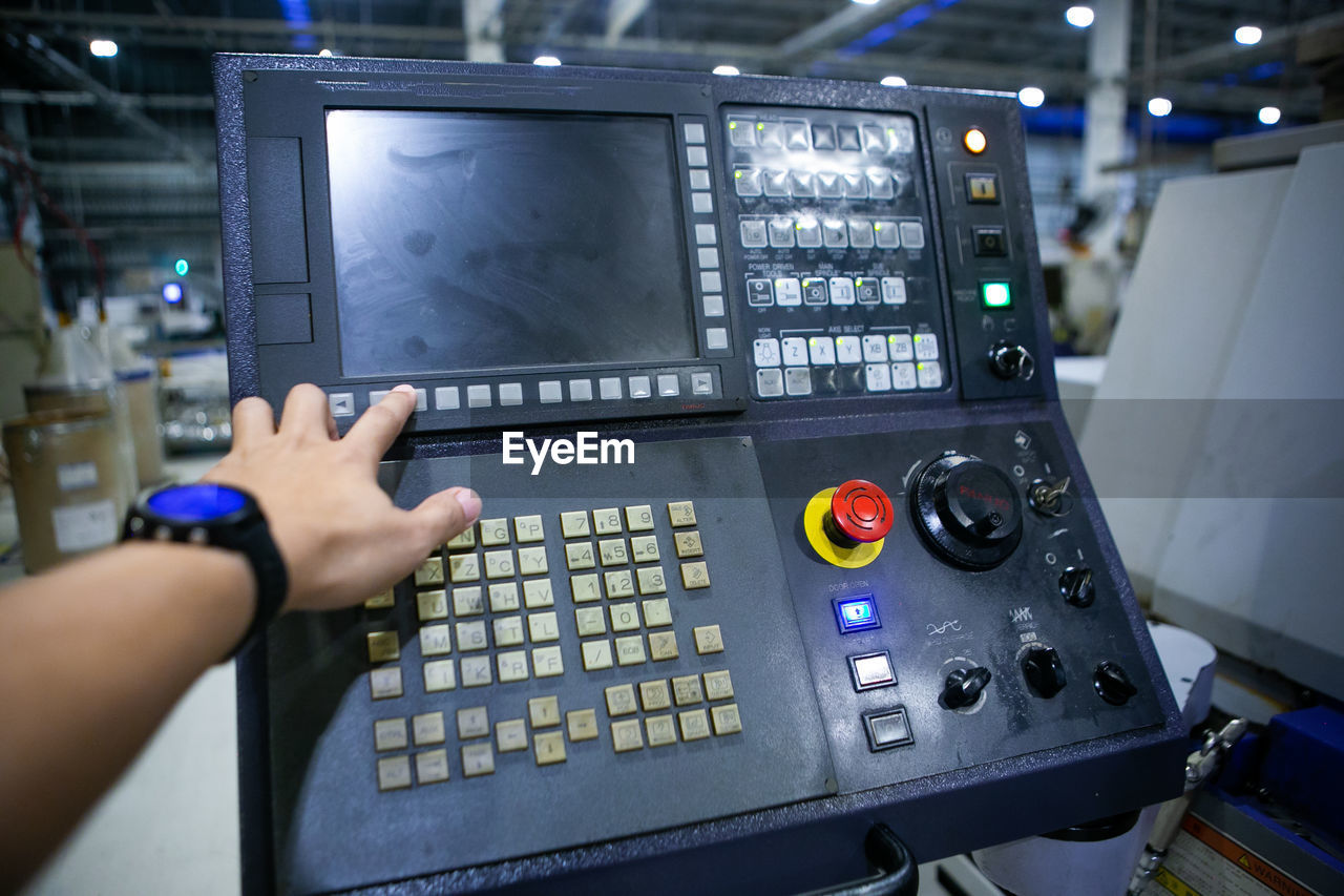 cropped hand of man using sound mixer