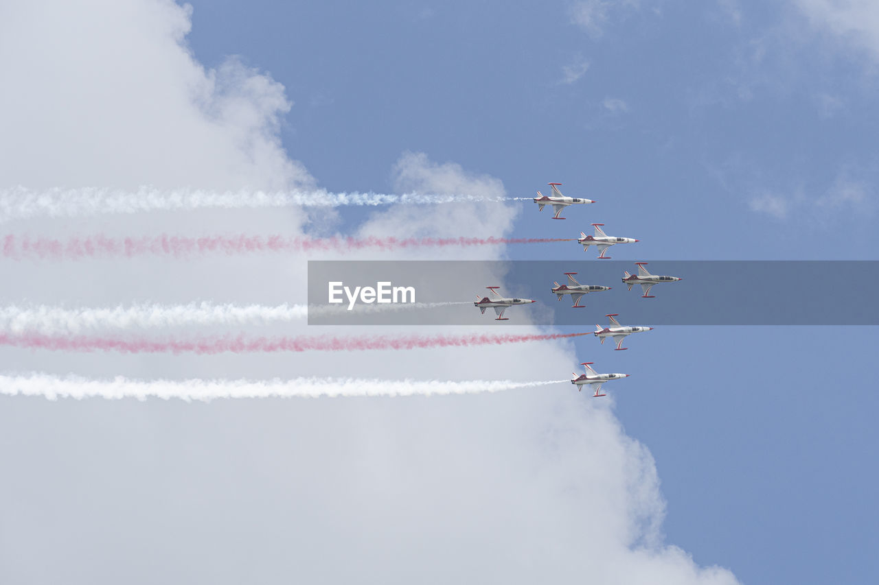 Low angle view of airplane flying against sky