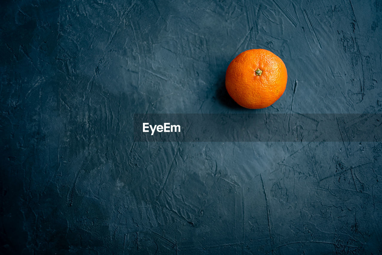 Isolated tangerine fruit on dark slate background. view from above with copy space for text