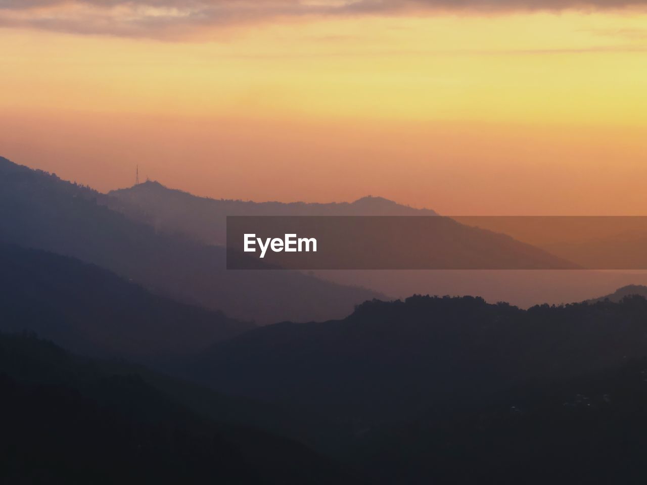 Scenic view of silhouette mountains against sky during sunset