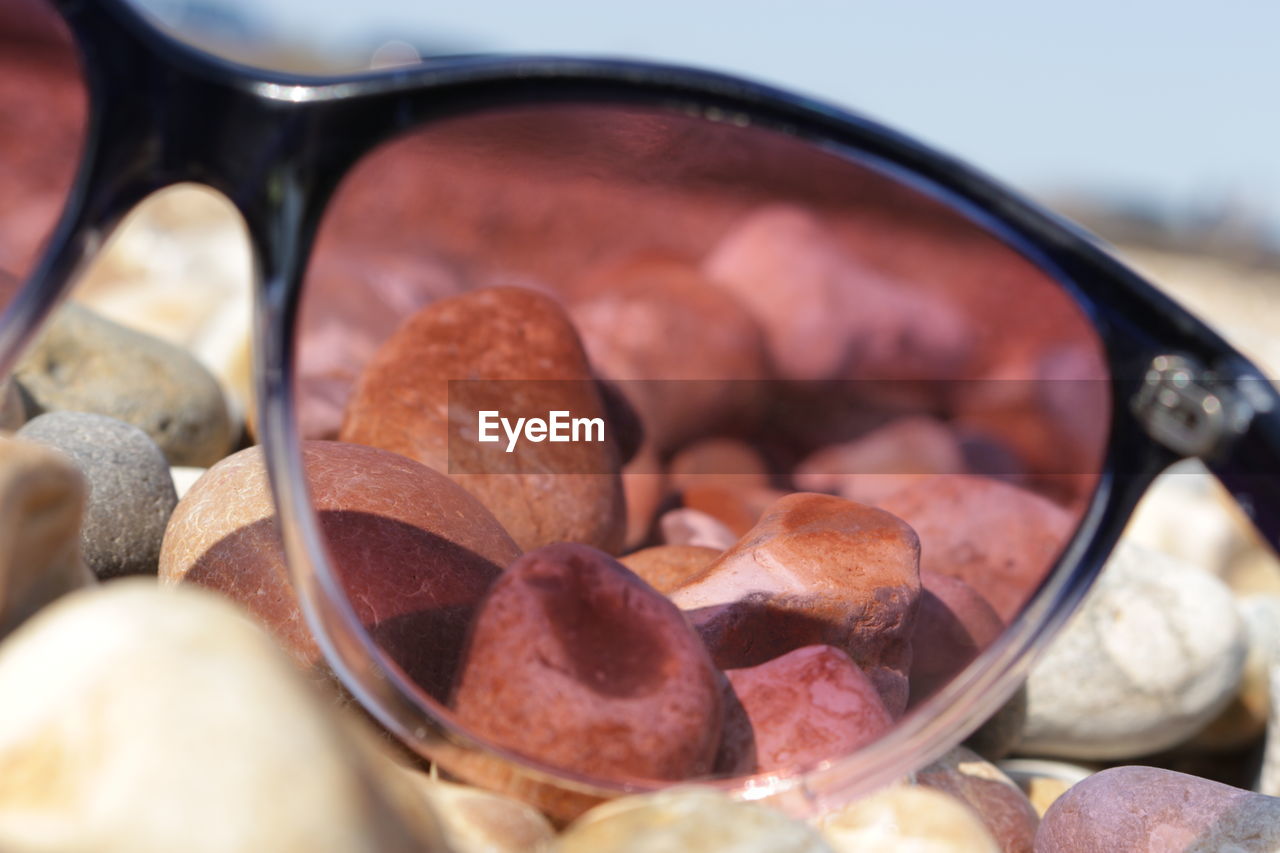 Close-up of sunglasses on pebbles