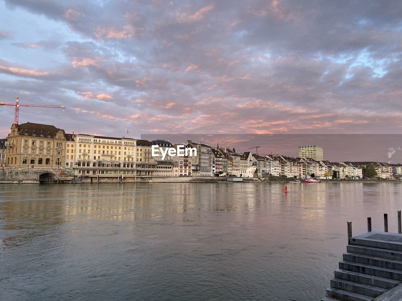 Bridge over river against buildings in city