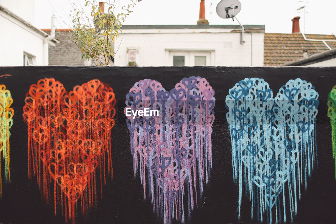 LOW ANGLE VIEW OF CLOTHES HANGING ON WALL