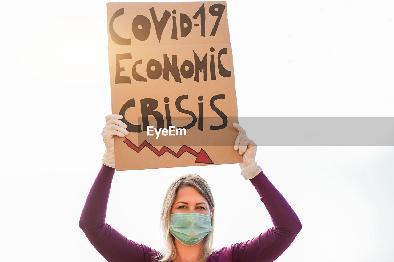 PORTRAIT OF YOUNG WOMAN WITH TEXT ON WHITE BACKGROUND