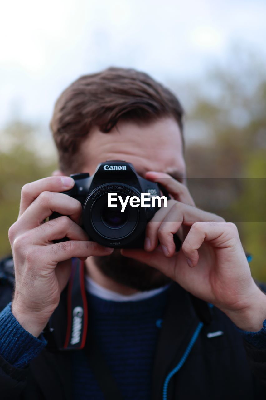 MAN PHOTOGRAPHING CAMERA