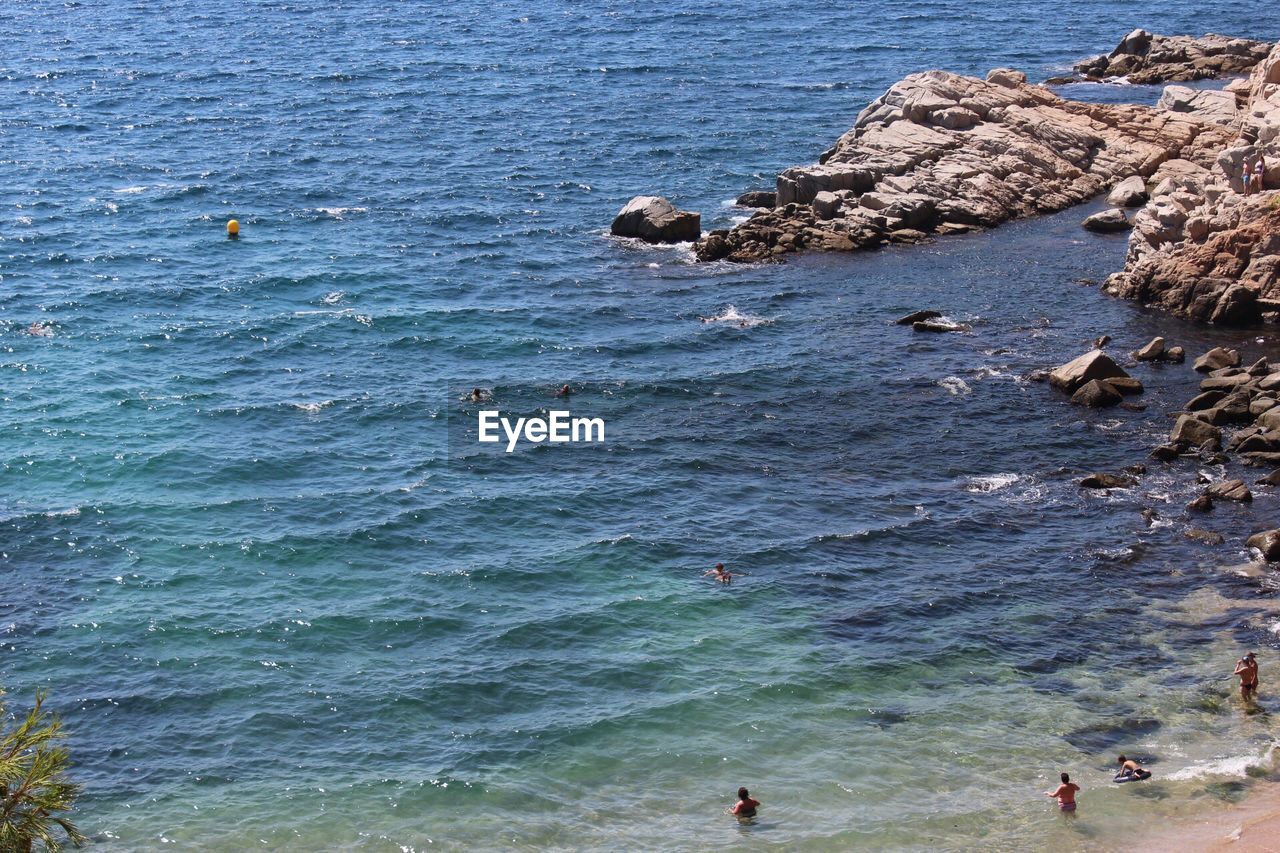 People swimming in sea