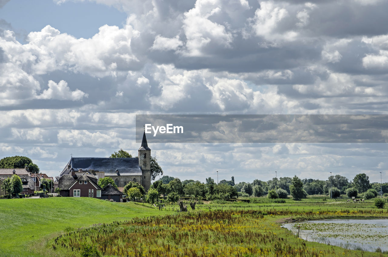 Village with church, floodplain and sky