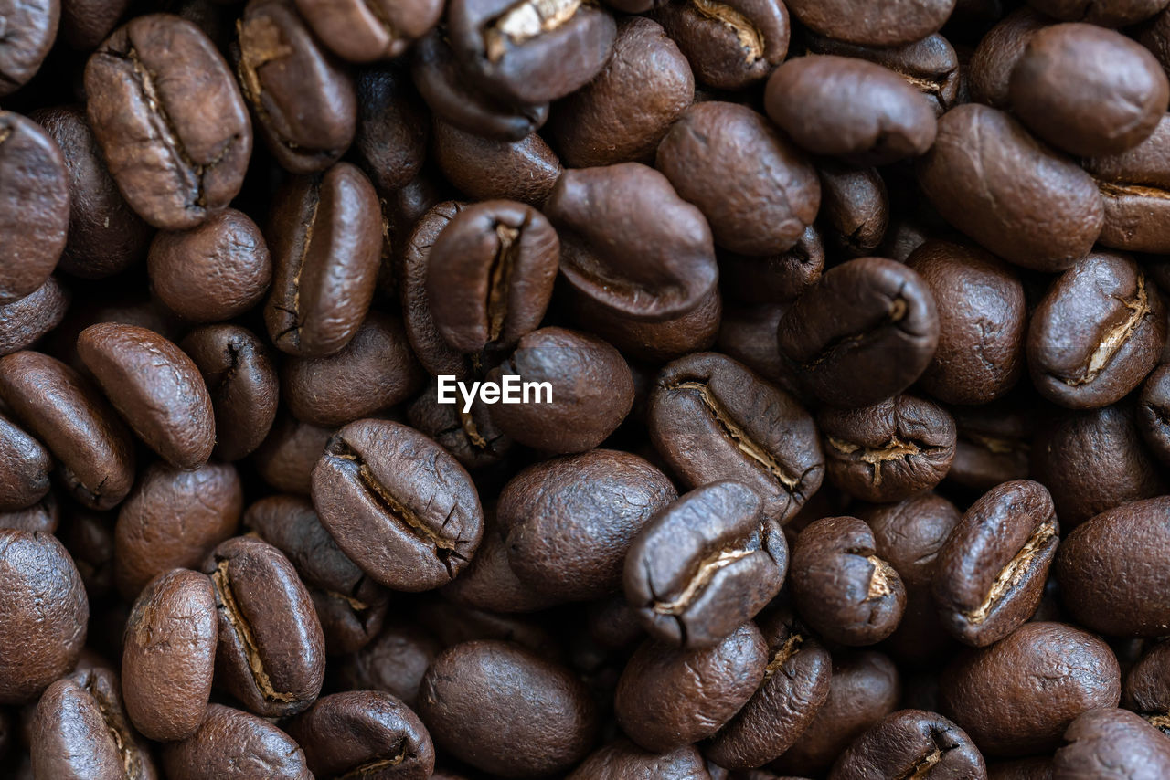 FULL FRAME SHOT OF COFFEE BEANS IN BACKGROUND