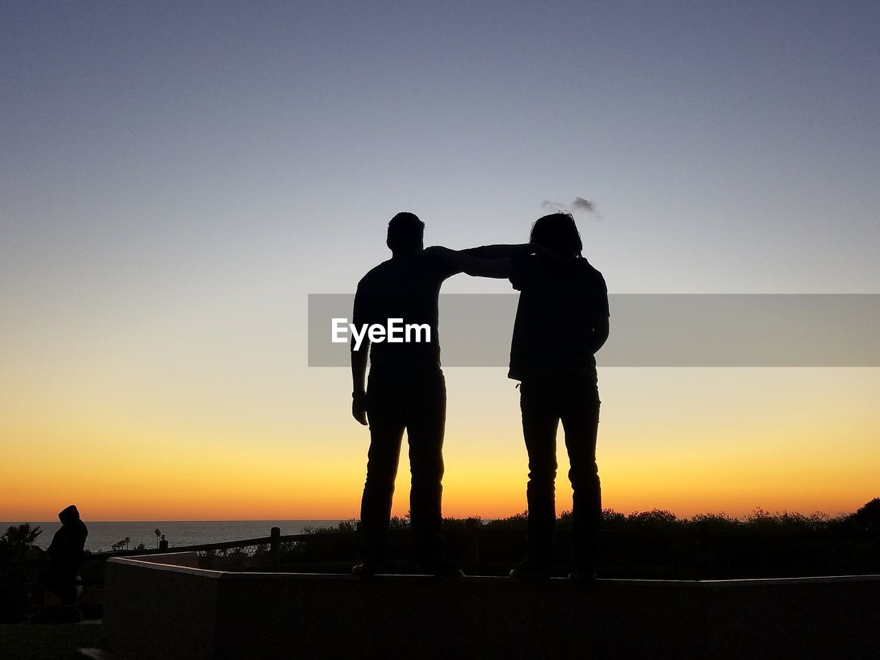 SILHOUETTE MEN STANDING AGAINST CLEAR SKY