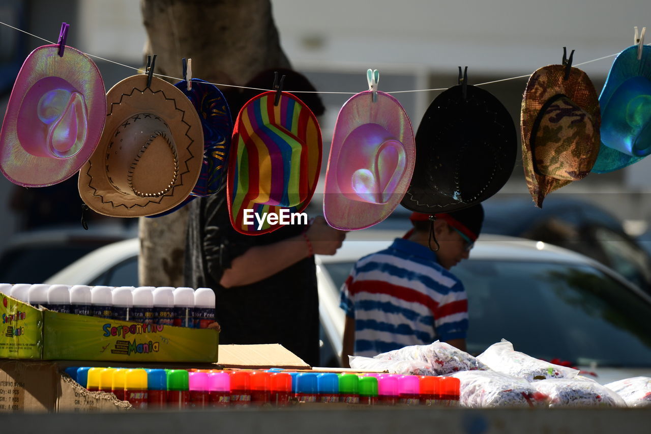 VARIOUS TOYS HANGING IN MARKET STALL