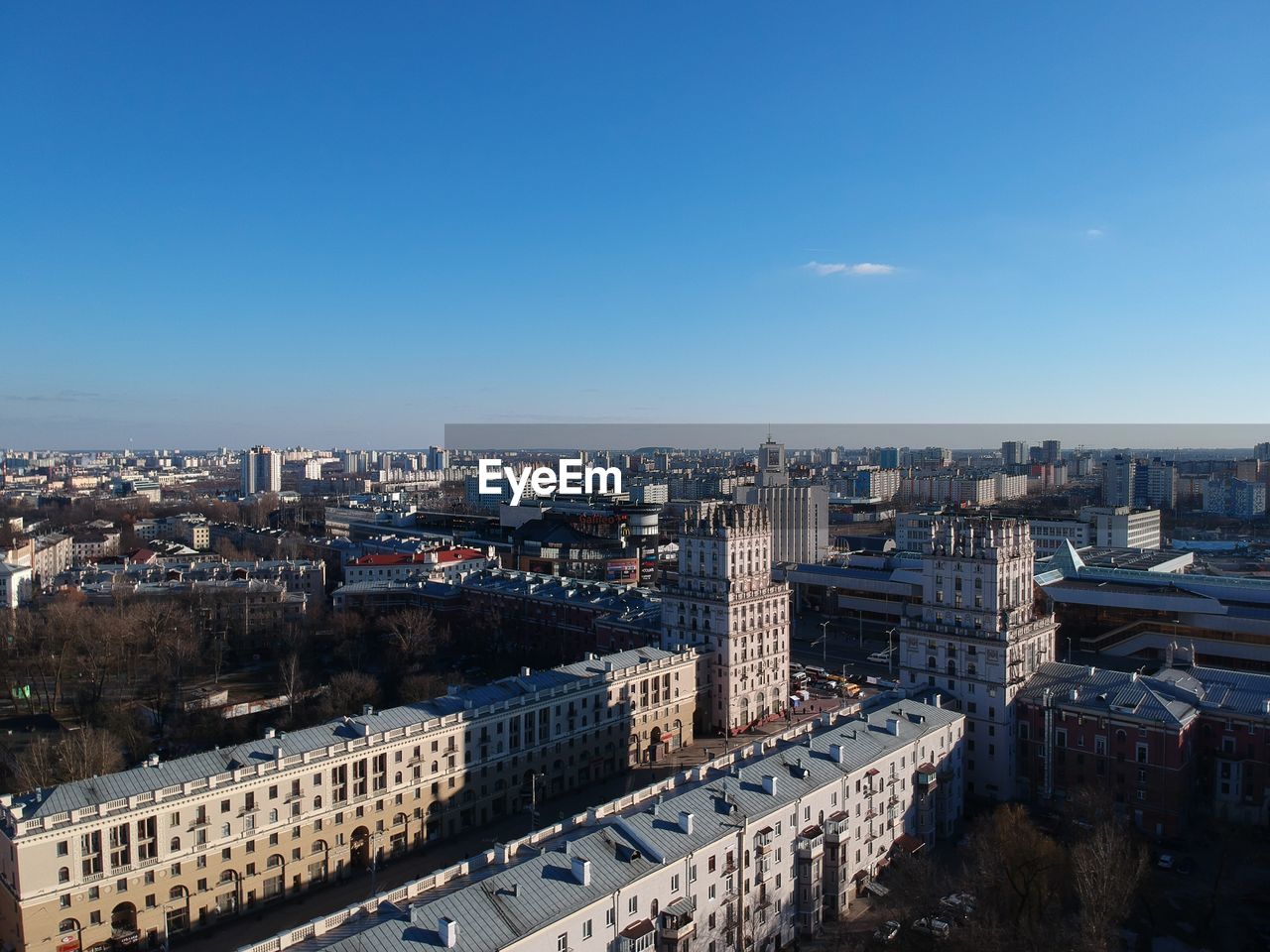 High angle view of city buildings against clear blue sky