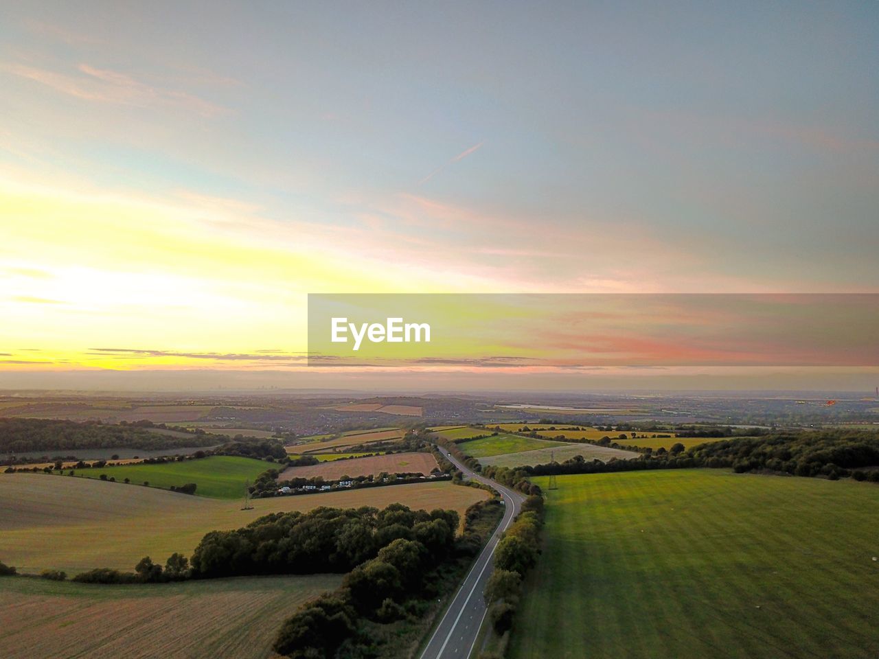 AERIAL VIEW OF AGRICULTURAL LANDSCAPE DURING SUNSET