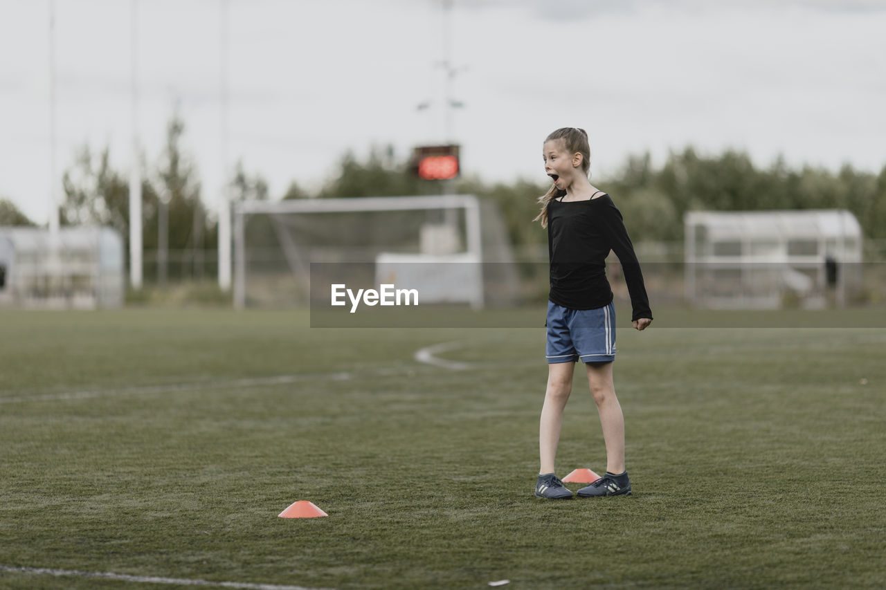 Girl on football pitch