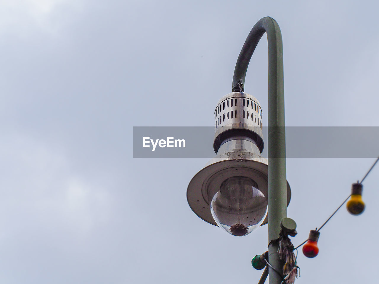 Low angle view of lamp post against sky