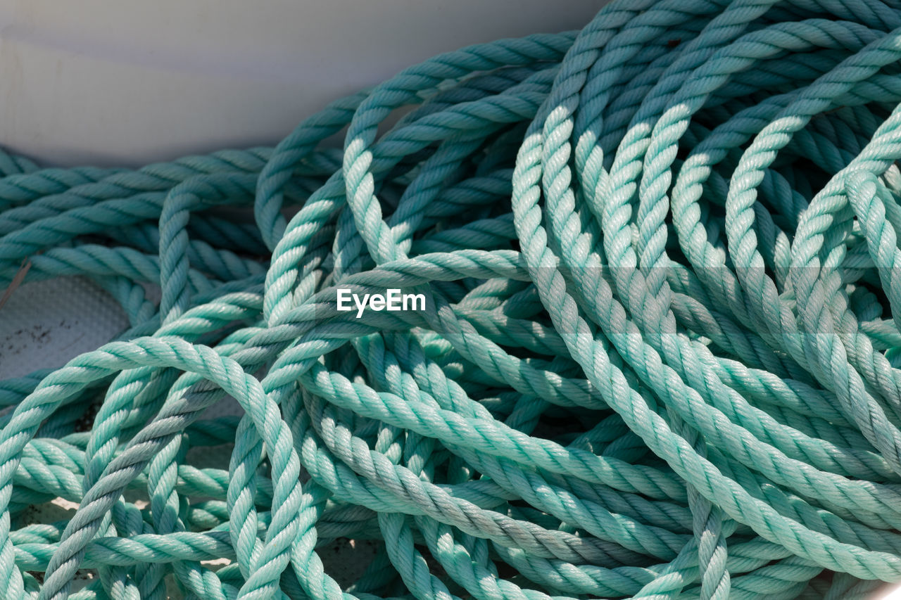 High angle view of turquoise ropes at harbor