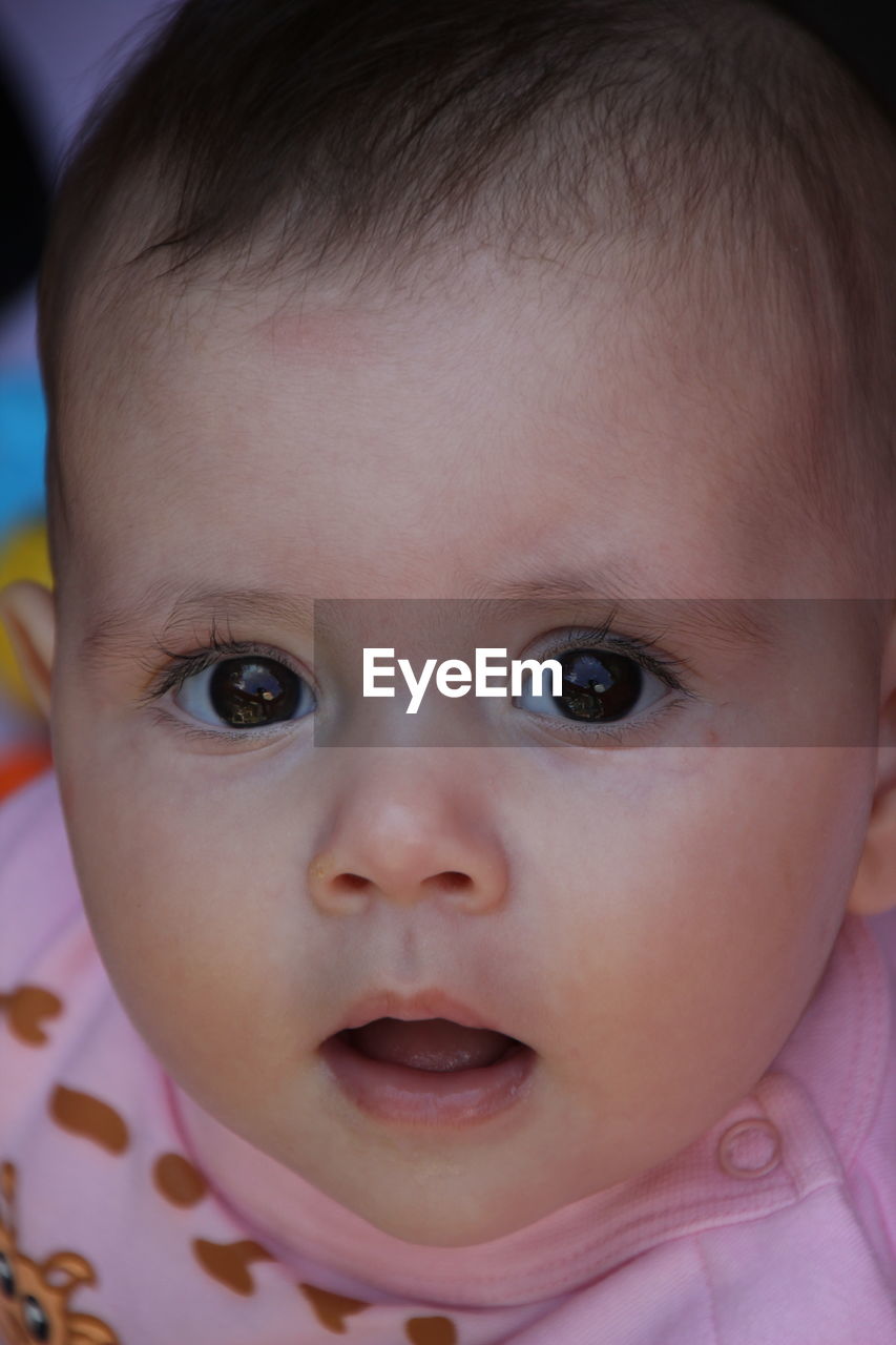 Close-up portrait of cute baby girl at home