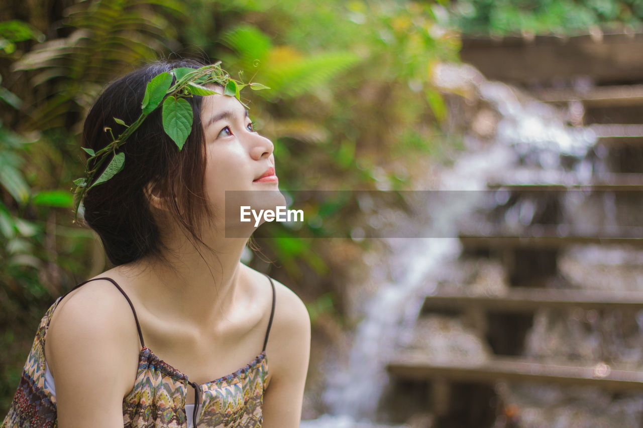 Close-up of beautiful young woman looking away 
