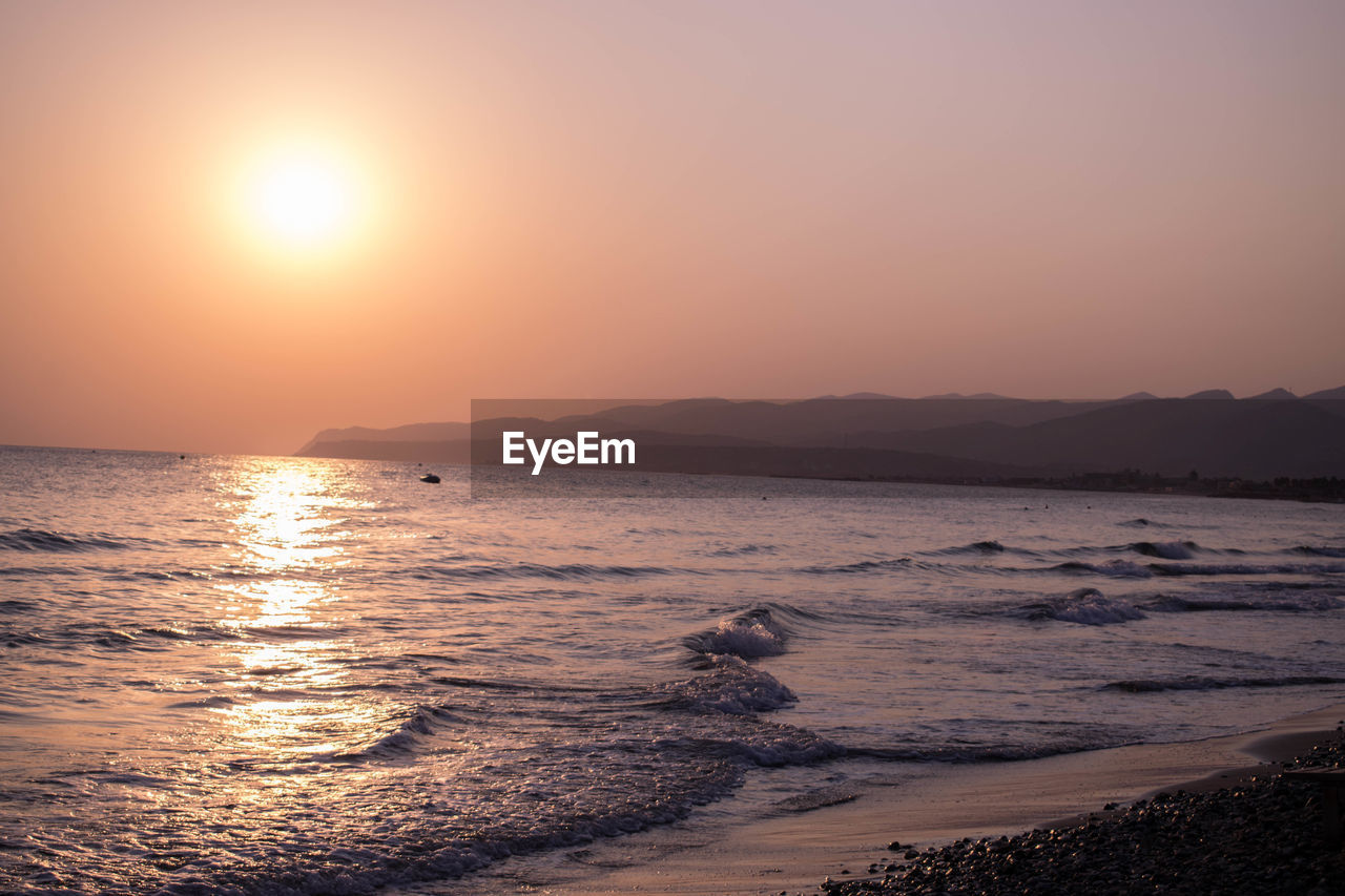 Scenic view of sea against clear sky during sunset