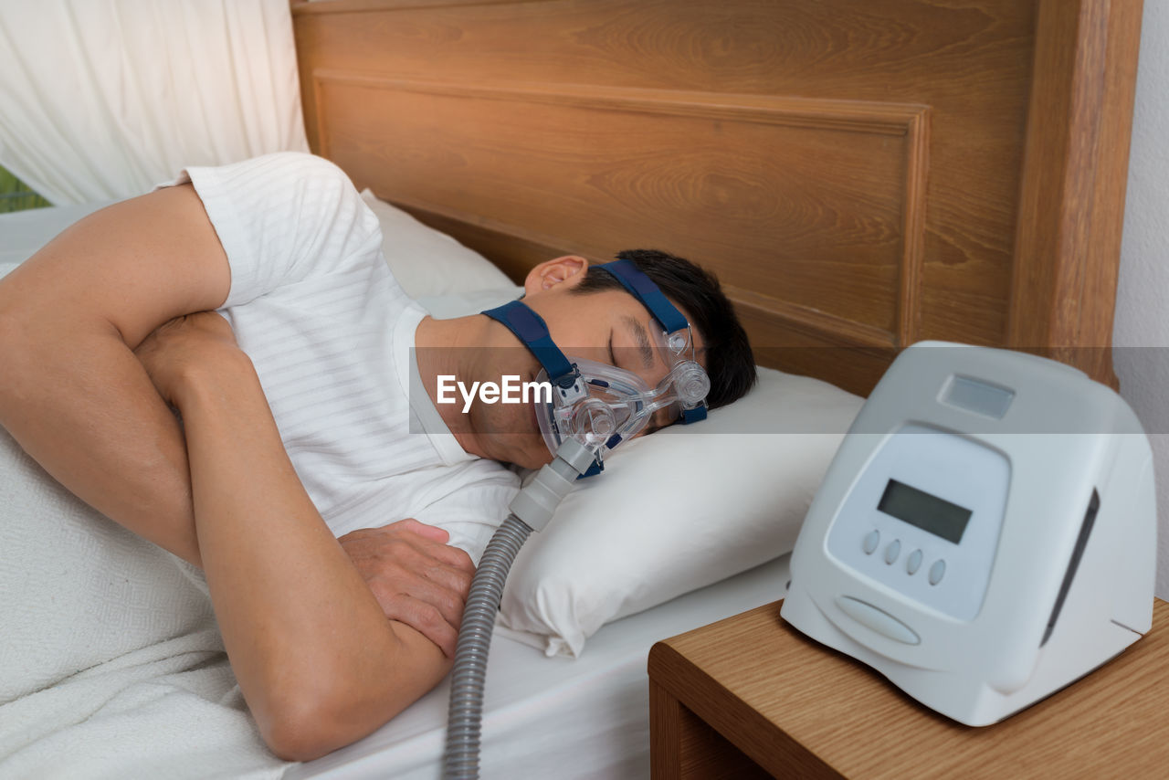 Young man taking apnea treatment