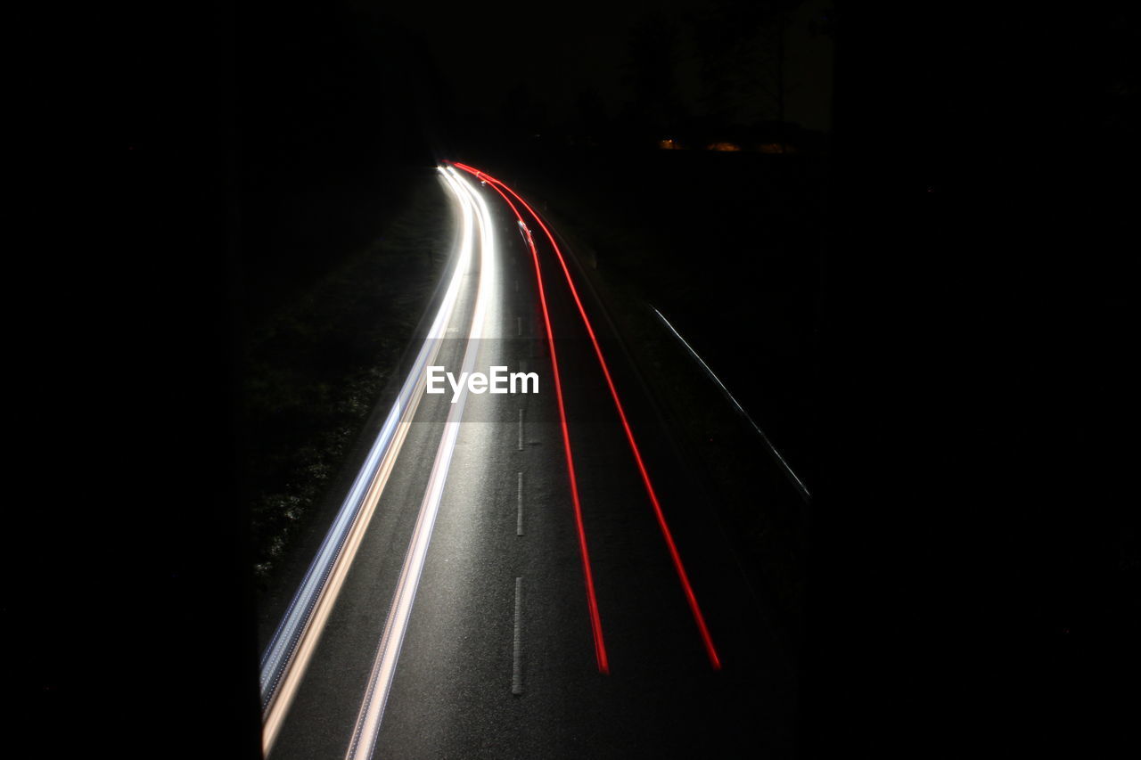 LIGHT TRAILS ON ROAD AT NIGHT