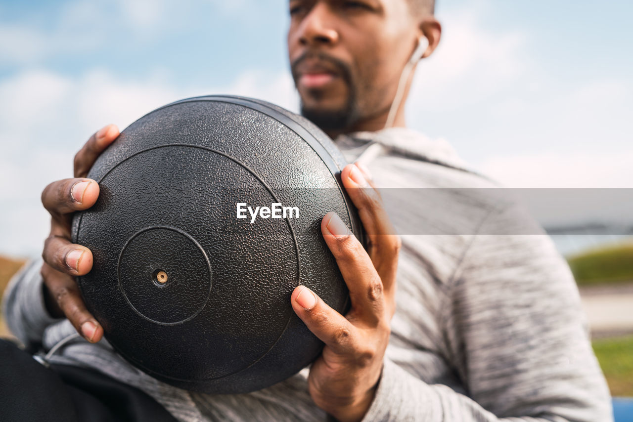 Close-up of man exercising with medicine ball