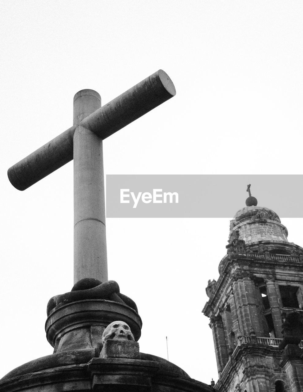 Low angle view cross and church against clear sky