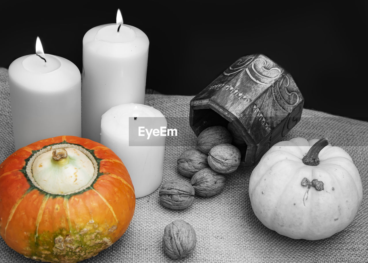 HIGH ANGLE VIEW OF PUMPKIN ON TABLE AGAINST BLACK BACKGROUND