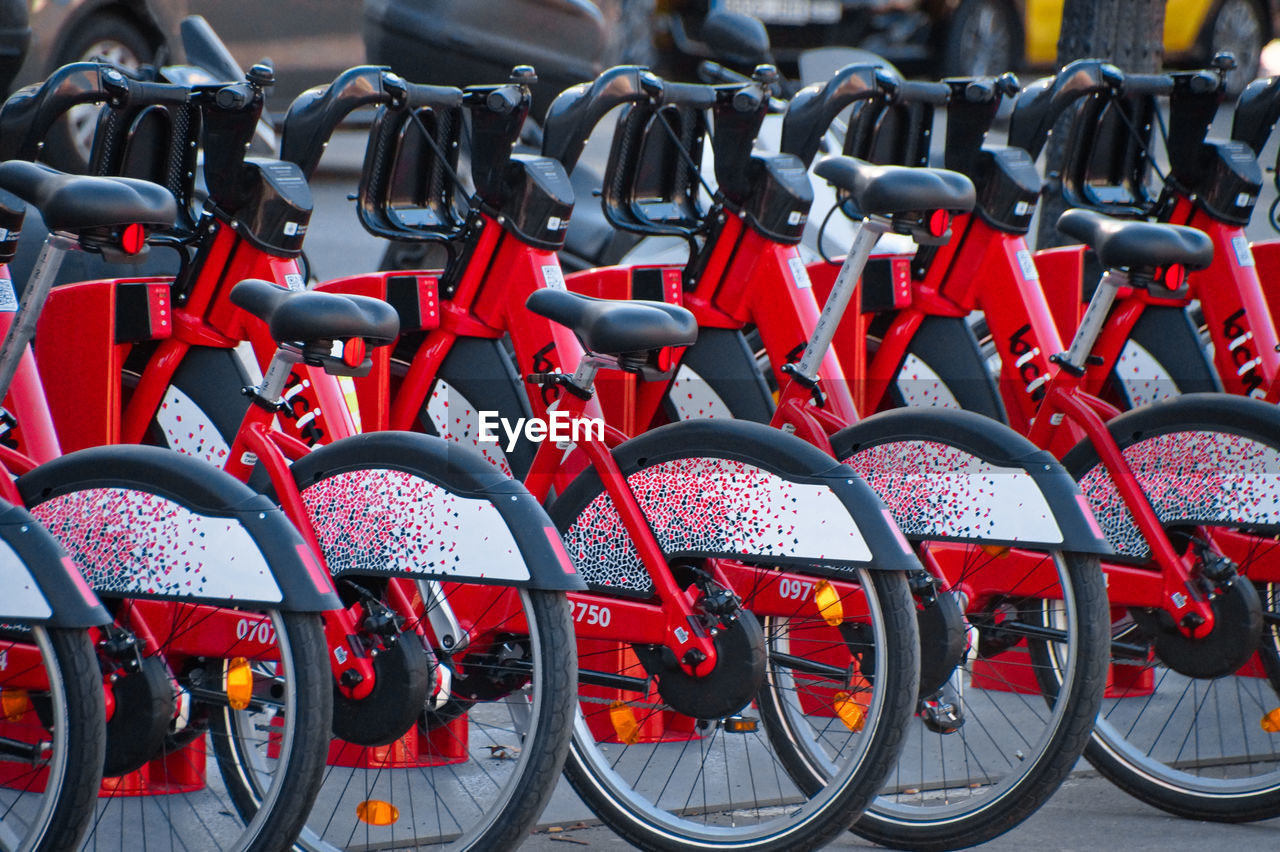 Red bicycles parked in row at city