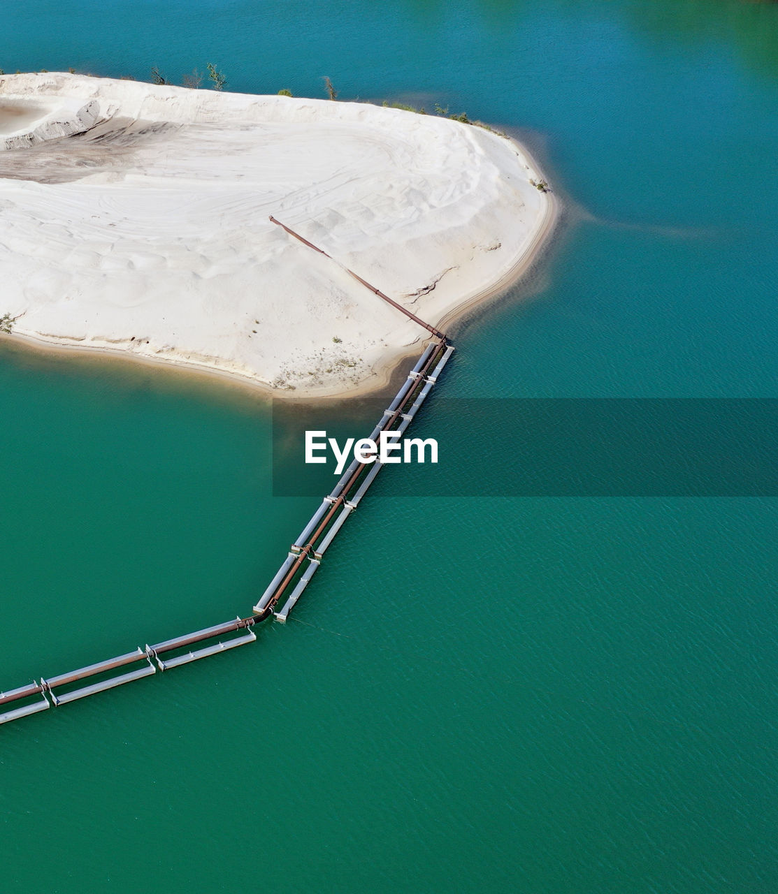 Abstract aerial view of a sand tongue in a gravel pond  