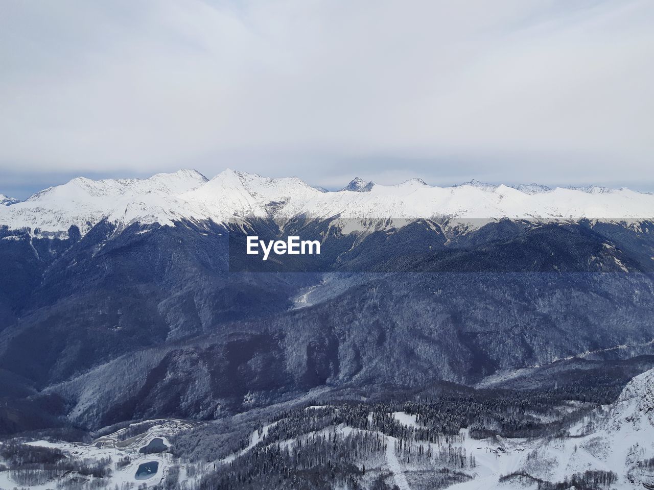 SNOW COVERED MOUNTAINS AGAINST SKY