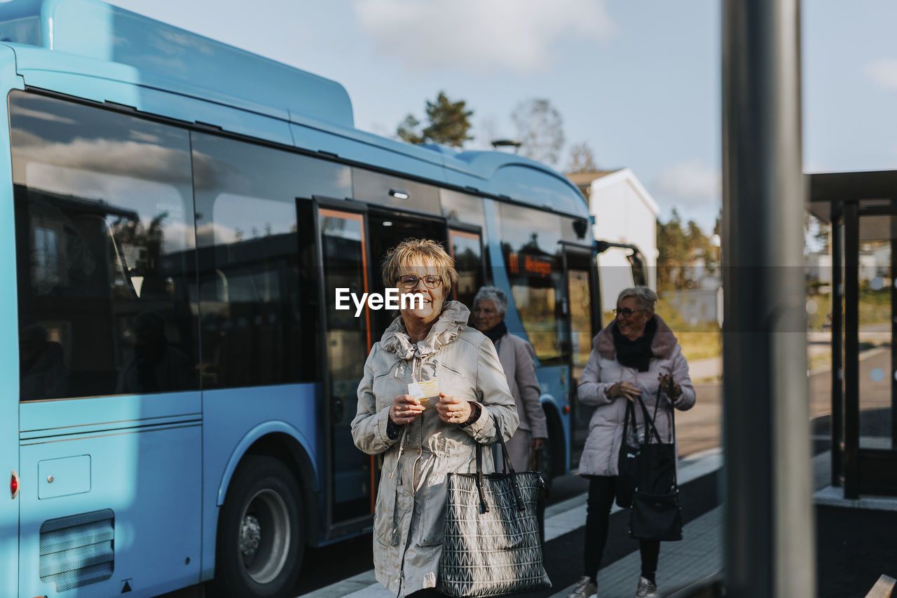 Smiling woman at bus station