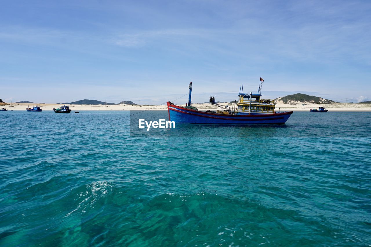 Fishing boats in sea against sky in van phong bay, khanh hoa, viet nam