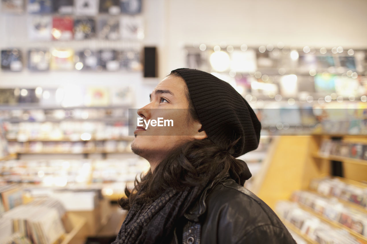 Young man browsing albums in a record store