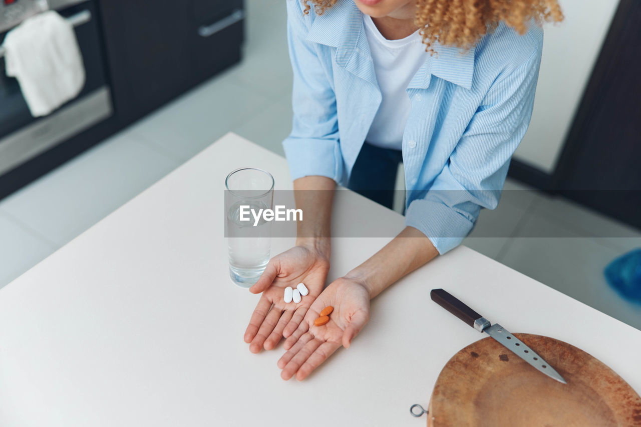 midsection of female doctor holding dentures