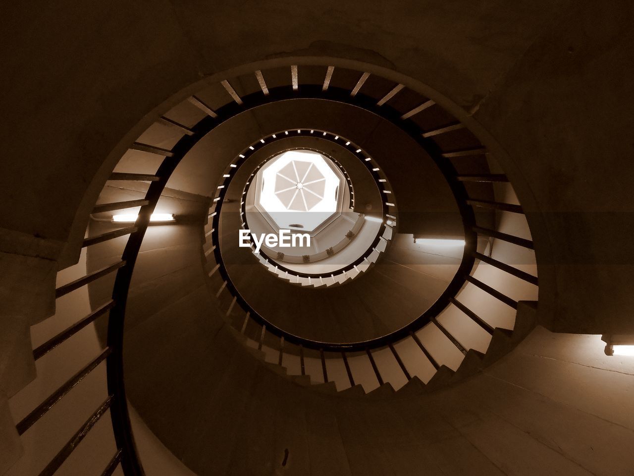 DIRECTLY BELOW SHOT OF SPIRAL STAIRCASE OF BUILDING