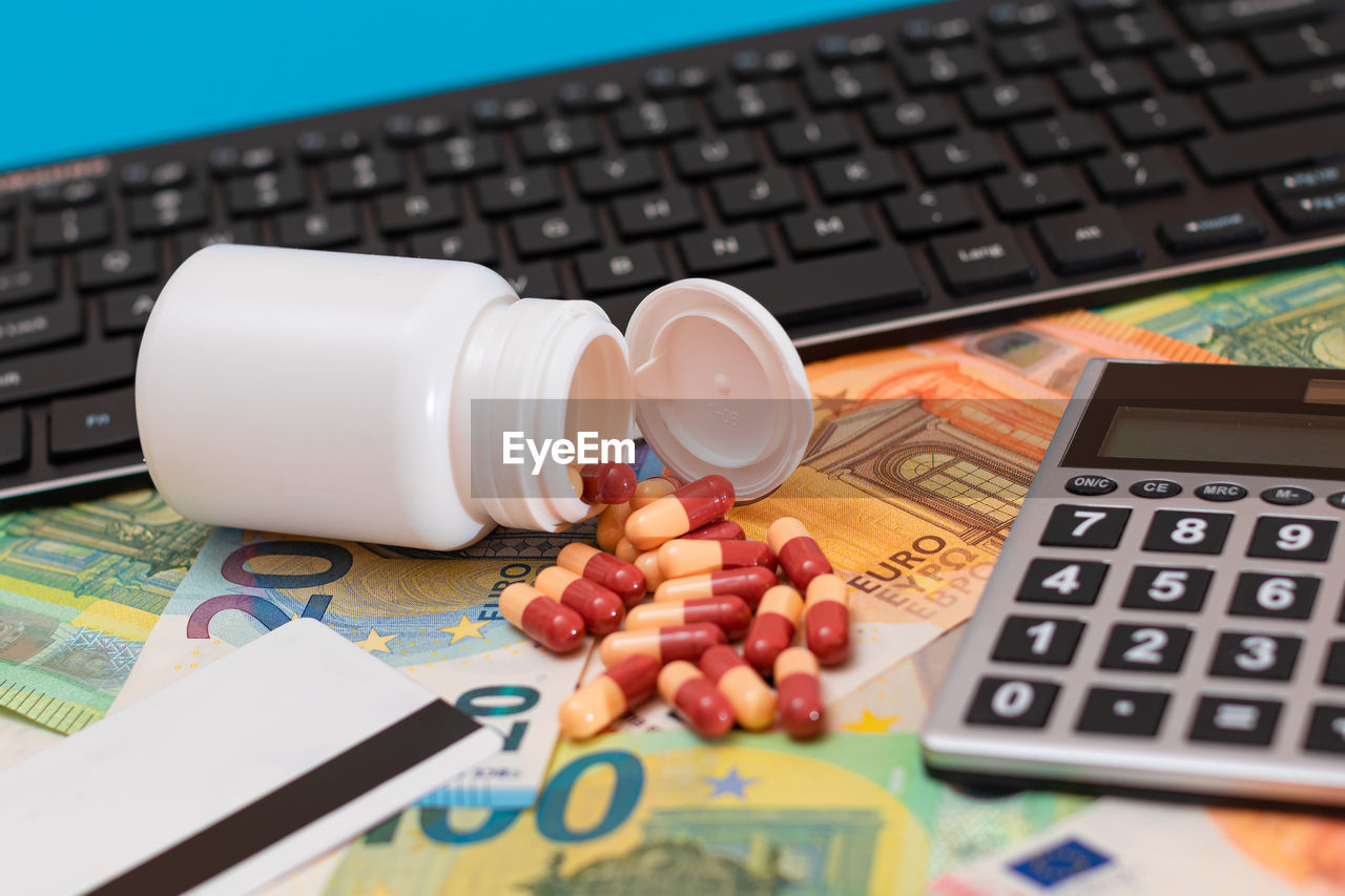 calculator, technology, business, finance, computer, wireless technology, pharmaceutical drug, drug, communication, computer keyboard, keyboard, currency, laptop, food and drink, computer equipment, indoors, no people, office equipment, table, corporate business