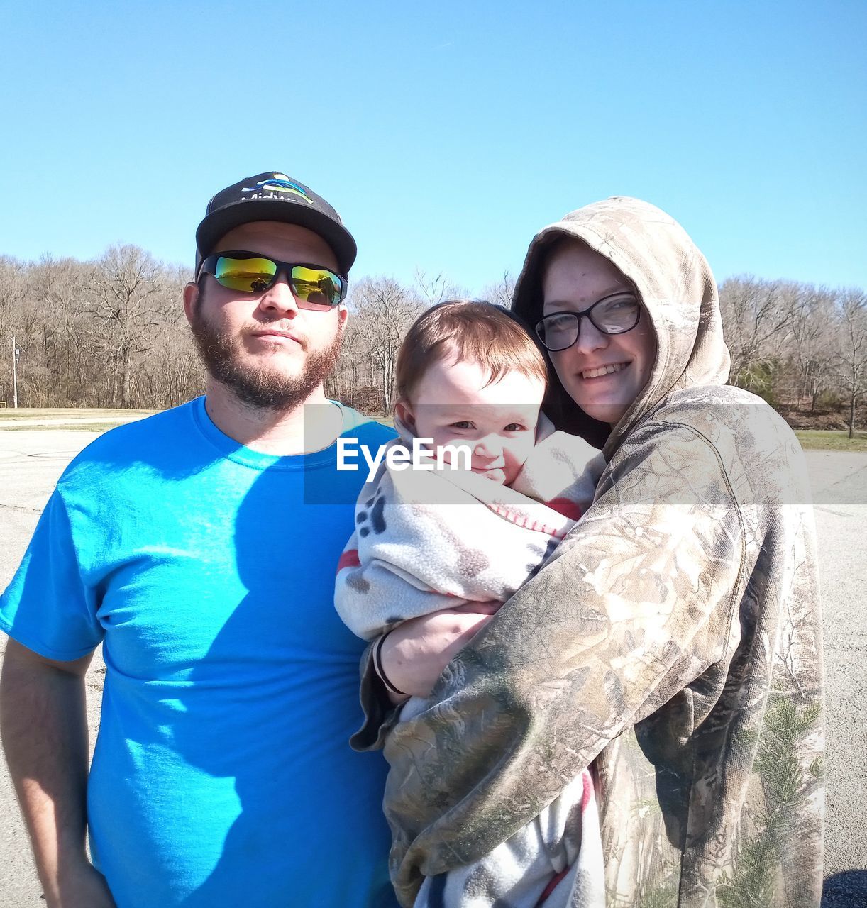 PORTRAIT OF FATHER WITH SON AT PARK