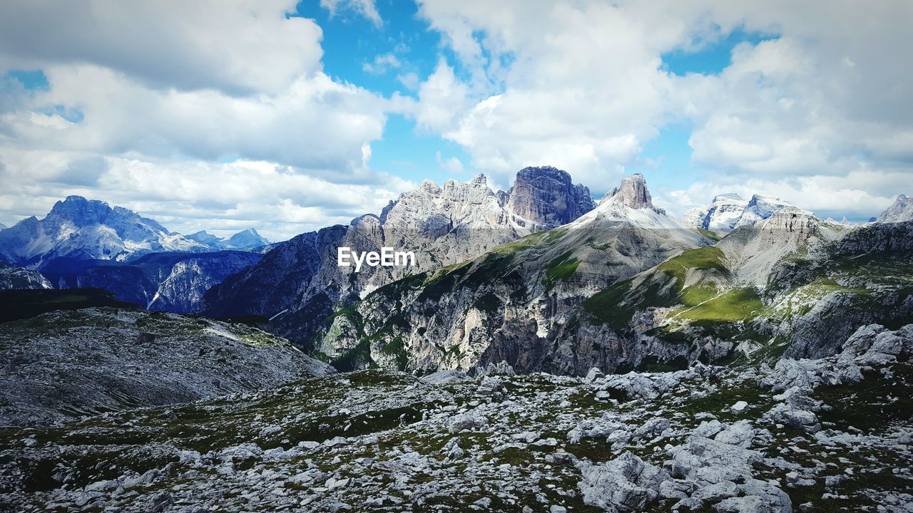 Distant view of tre cime di lavaredo against cloudy sky