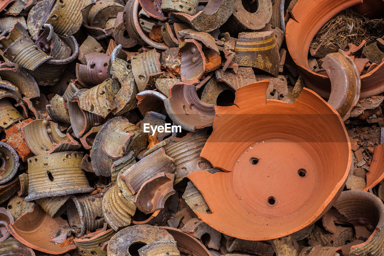 FULL FRAME SHOT OF RUSTY STACK OF FIREWOOD