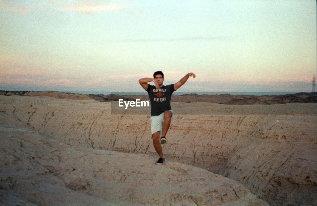 FULL LENGTH PORTRAIT OF MAN STANDING ON LAND