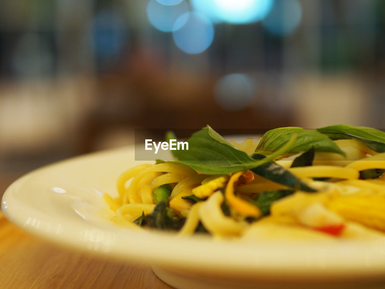 food and drink, food, freshness, healthy eating, dish, italian food, wellbeing, herb, plate, selective focus, cuisine, table, meal, pasta, close-up, no people, indoors, vegetable, produce, defocused, restaurant, yellow, leaf, spaghetti, fruit