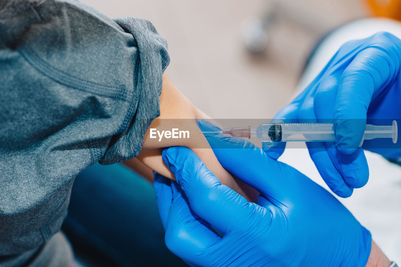 Close-up of doctor giving injection to patient