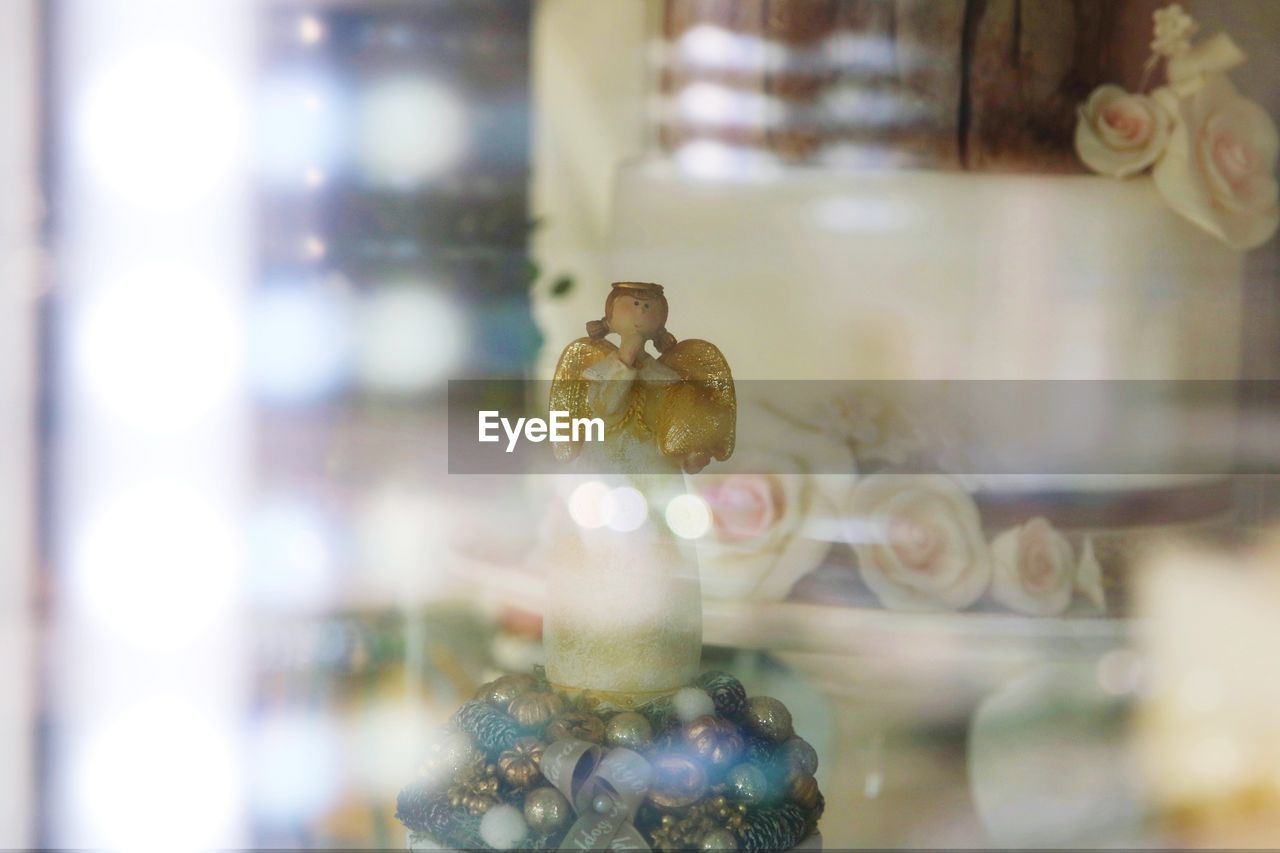 CLOSE-UP OF FIGURINE ON WINDOW SILL