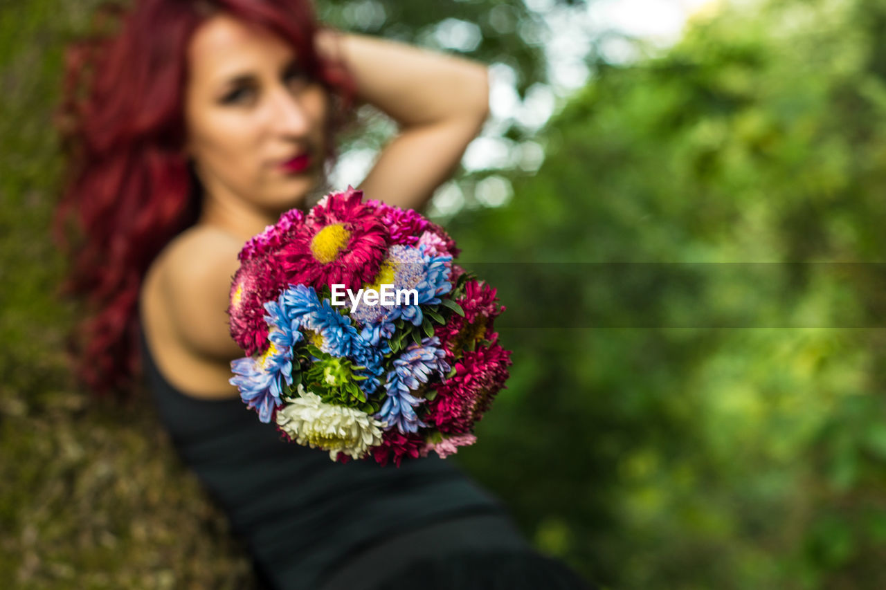 WOMAN HOLDING FLOWERS