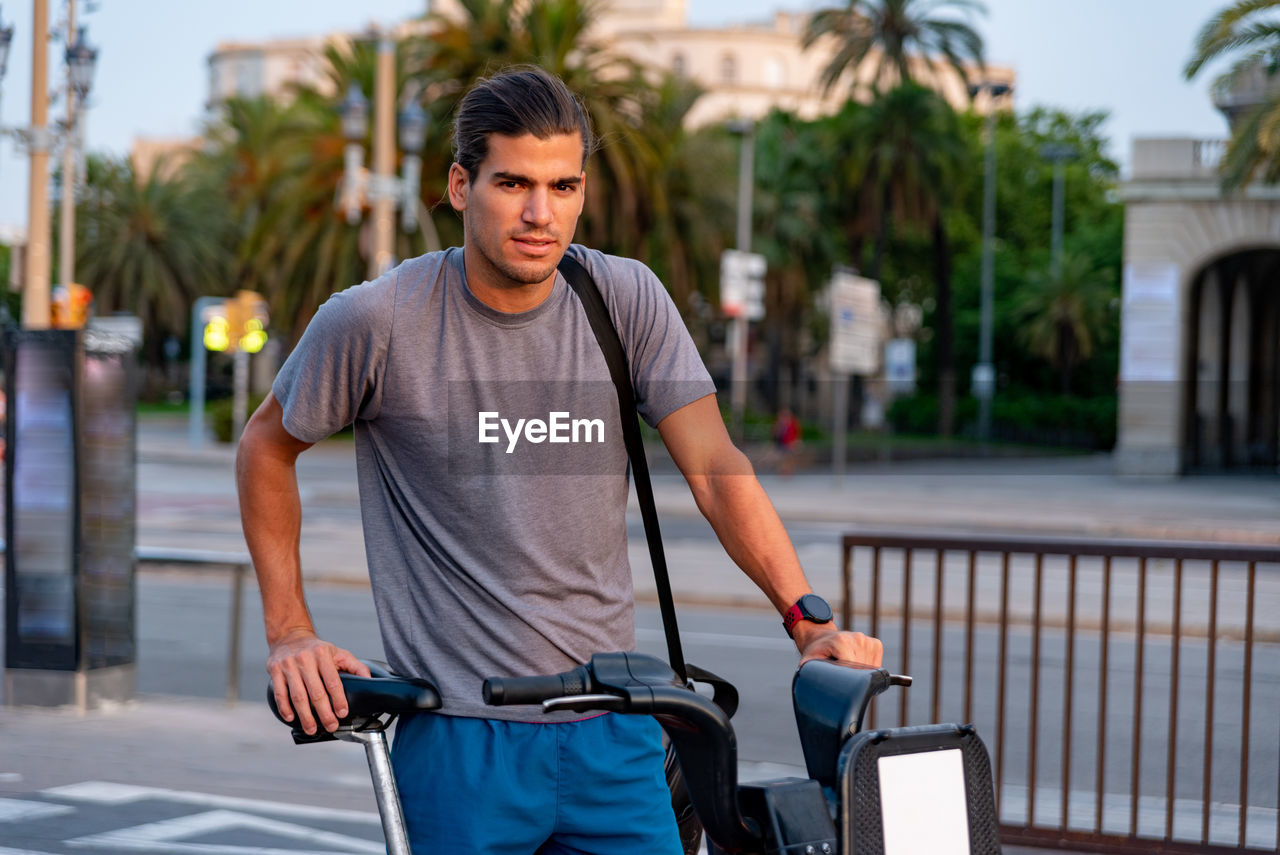 Young latin man with bicycle in the street