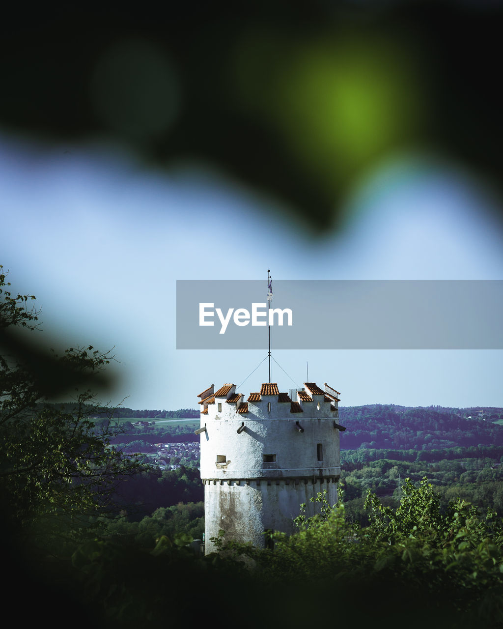 TRADITIONAL BUILDING BY TREES AGAINST SKY