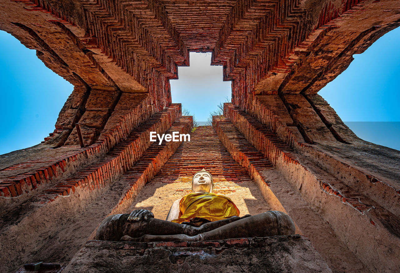 MAN SITTING IN TEMPLE