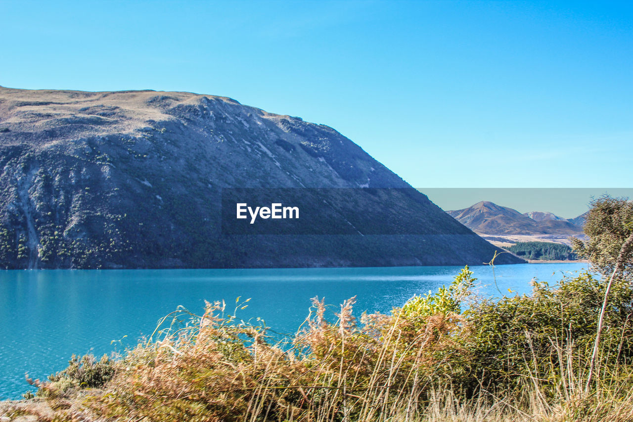 SCENIC VIEW OF LAKE AGAINST BLUE SKY