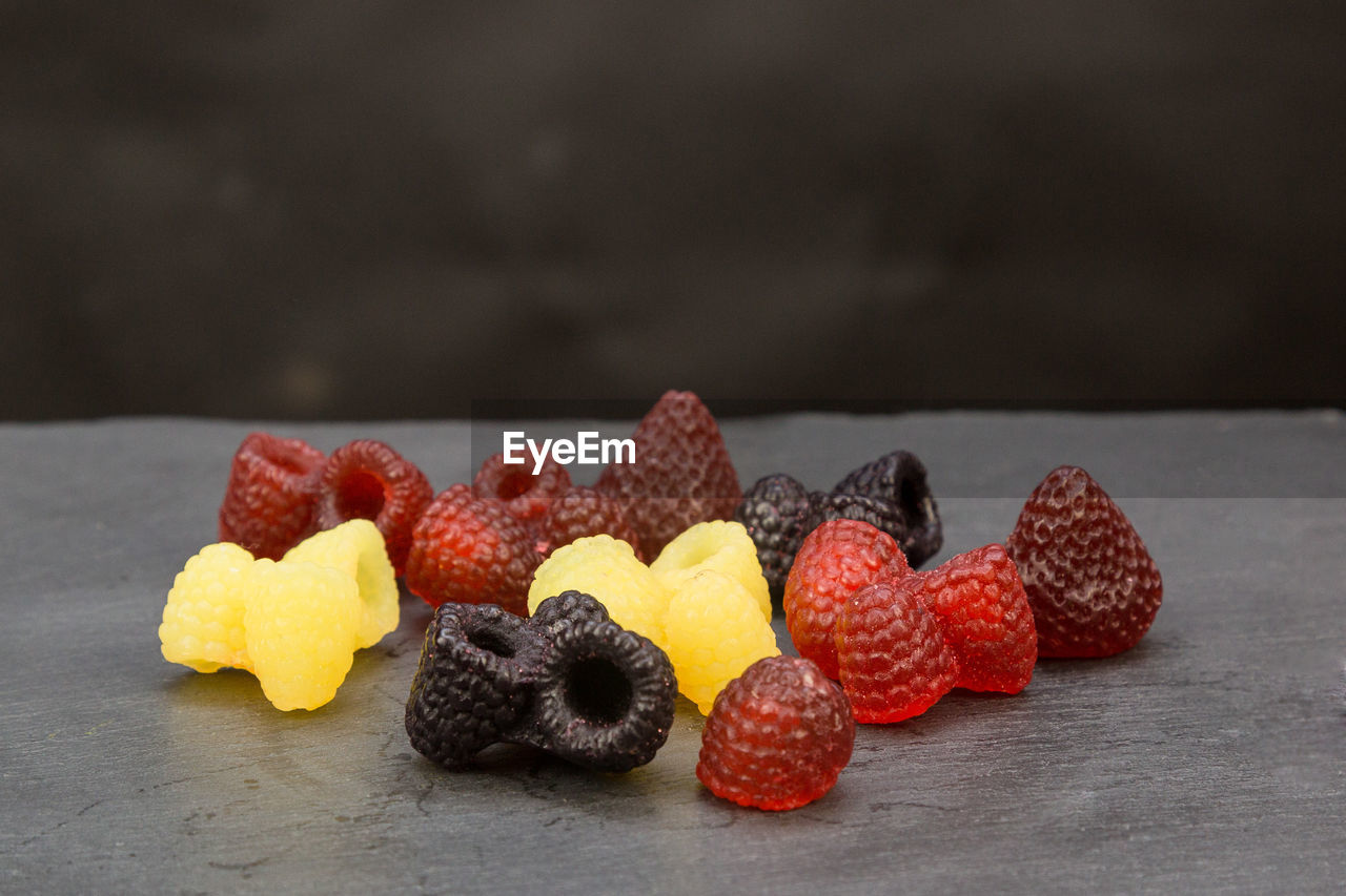 CLOSE-UP OF FRUITS ON WOODEN TABLE